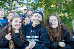 New Hampton School students cheer at a football game
