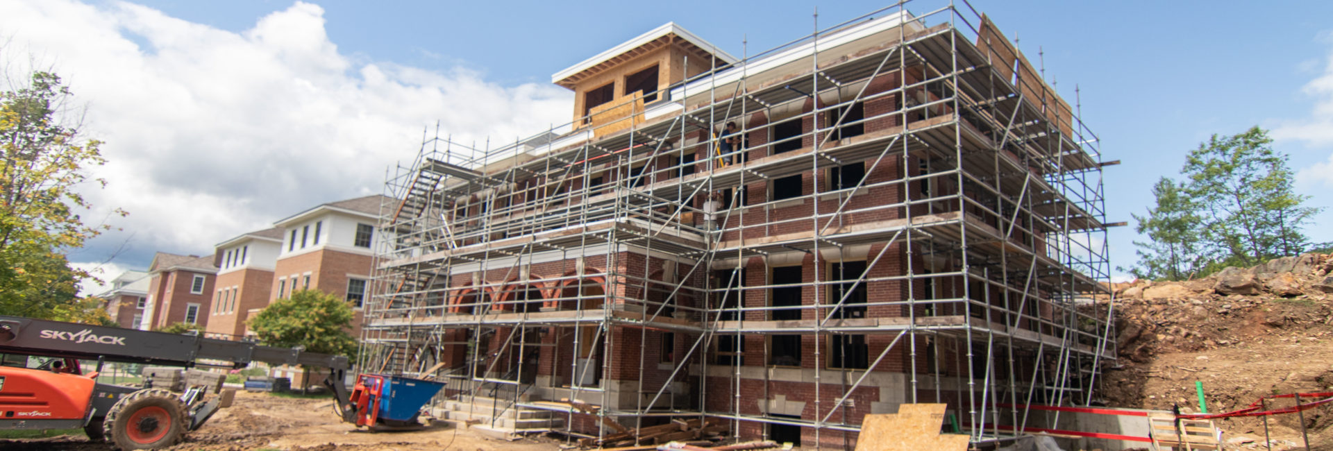 Exterior of brick building surrounded by metal scaffolding